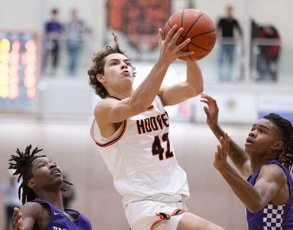 Hoover’s Hunter Hershberger splits Barberton’s defenders during the Hoover Hoops MLK Classic in January. Hershberger scored 9 points in Saturday's sectional final win over Avon Lake.