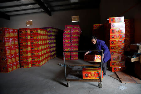 A worker carries pyrotechnic product at Liuyang Standard Fireworks Manufactory in Liuyang, Hunan province, China January 29, 2018, Picture taken January 29, 2018. REUTERS/Aly Song