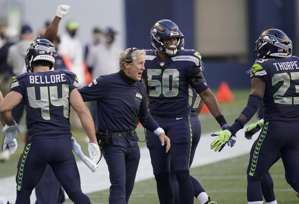 Seattle Seahawks head coach Pete Carroll celebrates with outside linebacker K.J. Wright (50) after wide receiver DK Metcalf scored a touchdown against the New England Patriots during the first half of an NFL football game, Sunday, Sept. 20, 2020, in Seattle. (AP Photo/Elaine Thompson)