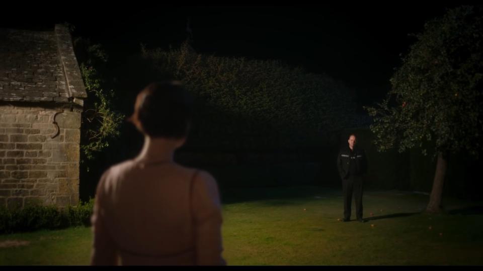 Harper looking at a police officer on her lawn in "Men"