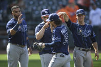 Tampa Bay Rays' Brett Phillips, front center, is greeted by teammates after their victory over the Baltimore Orioles in a baseball game Sunday, Aug. 8, 2021, in Baltimore. (AP Photo/Terrance Williams)