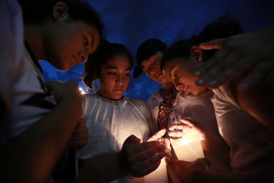 People gather in Juarez, Mexico, Saturday, Aug. 3, 2019, in a vigil for the 3 Mexican nationals who were killed in an El Paso shopping-complex shooting. Twenty people were killed and more than two dozen injured in a shooting Saturday in a busy shopping area in the Texas border town of El Paso, the state’s governor said. (AP Photo/Christian Chavez)