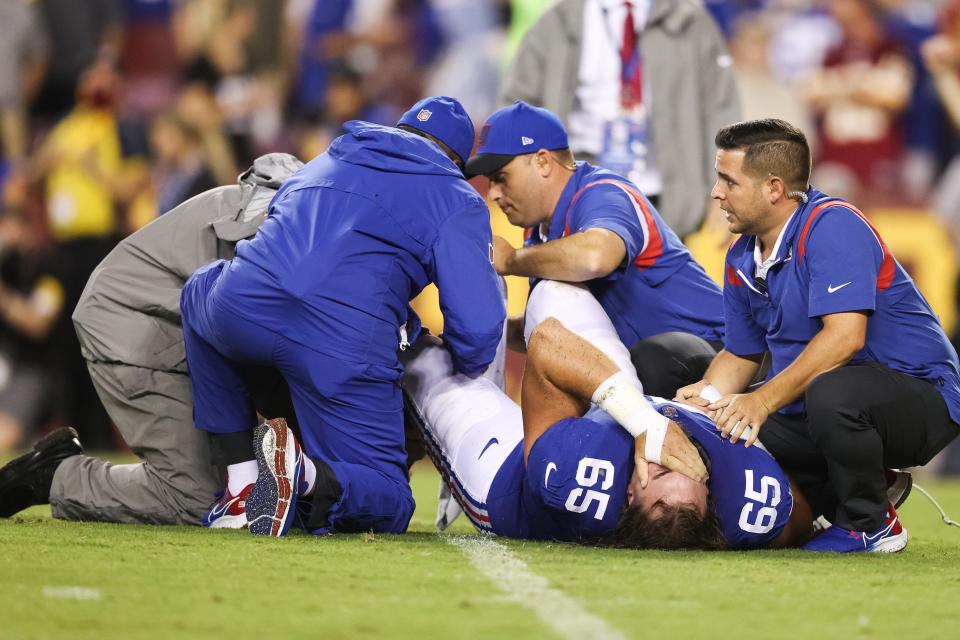 Nick Gates is tended to be medical staff after suffering a lower leg injury against the Washington Football Team  at FedExField.