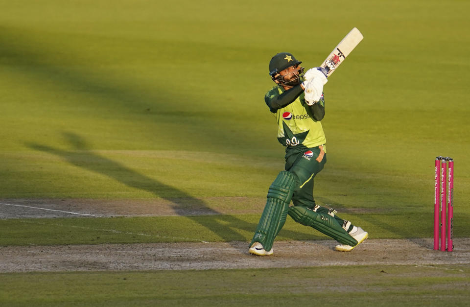 Pakistan's Mohammad Hafeez watches the ball after playing a shot during the third Twenty20 cricket match between England and Pakistan, at Old Trafford in Manchester, England, Tuesday, Sept. 1, 2020. (AP Photo/Jon Super, Pool)