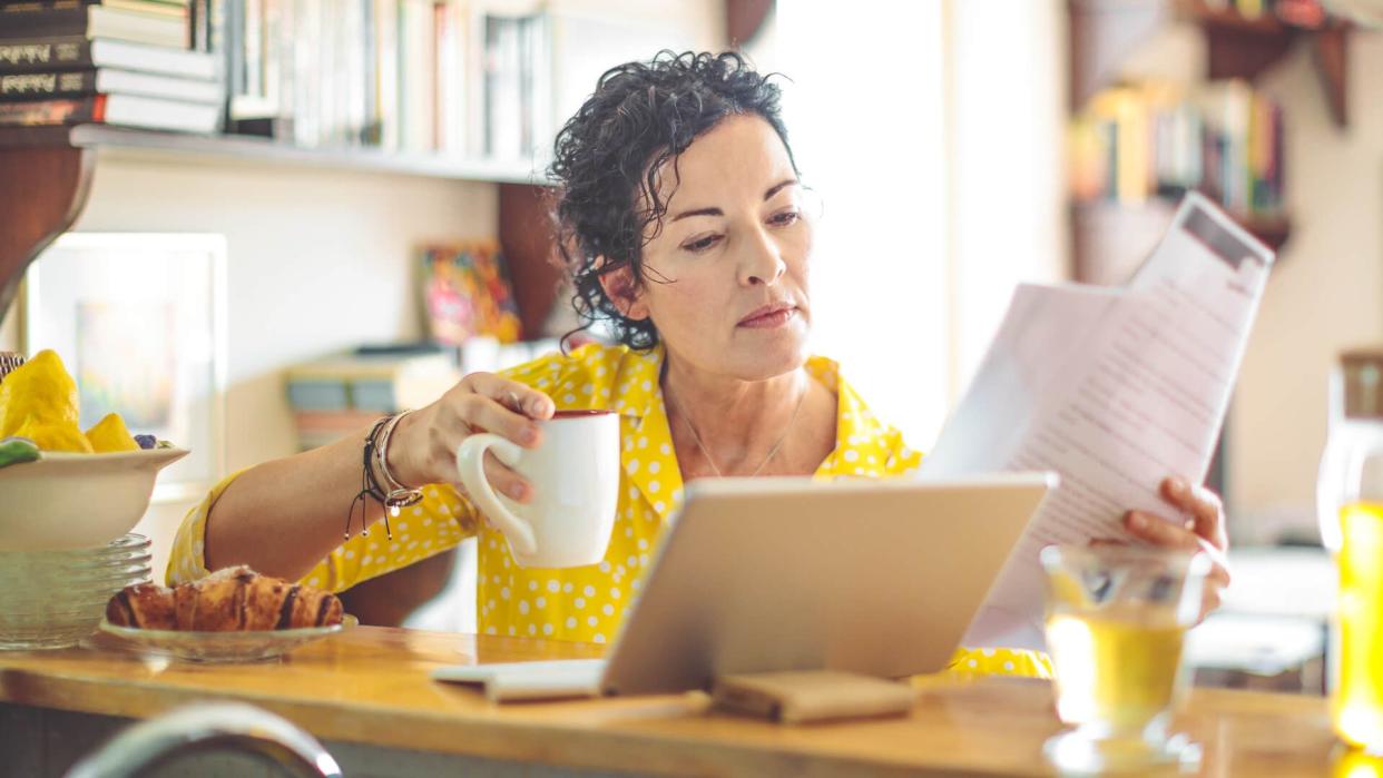 Mature woman is checking her finances at home.