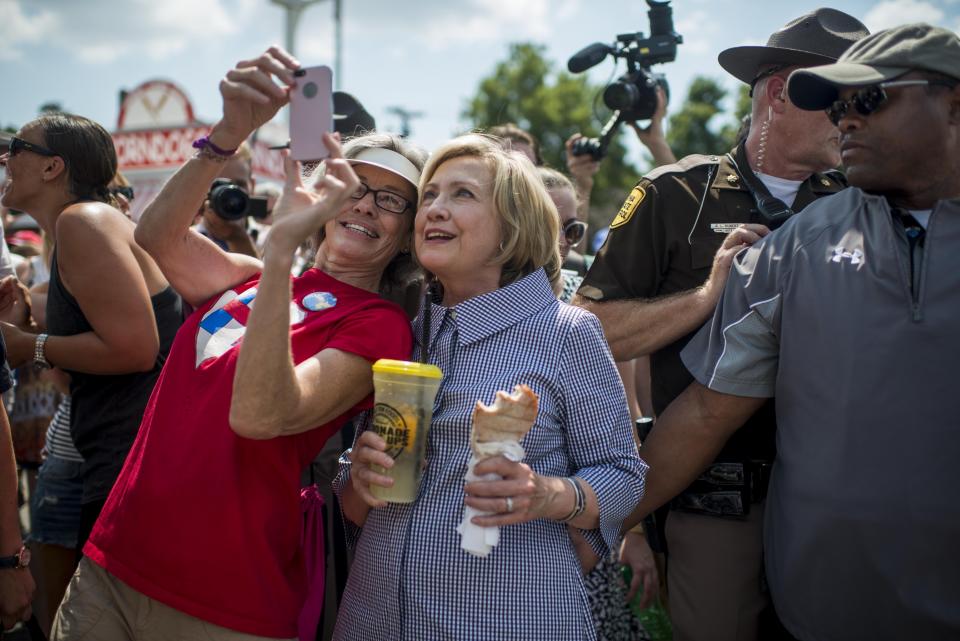 <p>Hillary Clinton poses for photos with fans.</p>