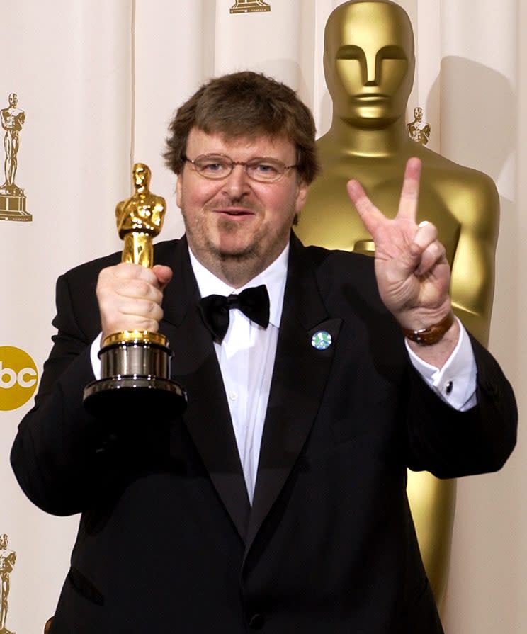 Michael Moore flashes a peace sign in the press room following his Oscar win. (Photo: Mark J. Terrill/AP)<br>