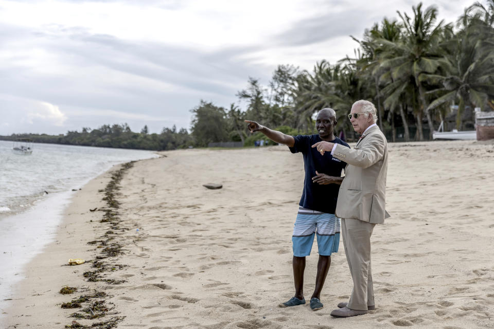 Britain's King Charles III, right, speaks to Katana Ngala, left, a coral restoration officer, as they observe from the beach as the coral he planted on concrete bricks is taken out to sea during a visit to Kuruwitu Conservation Area in Kilifi, Kenya, Thursday, Nov. 2, 2023. (Luis Tato/Pool Photo via AP)