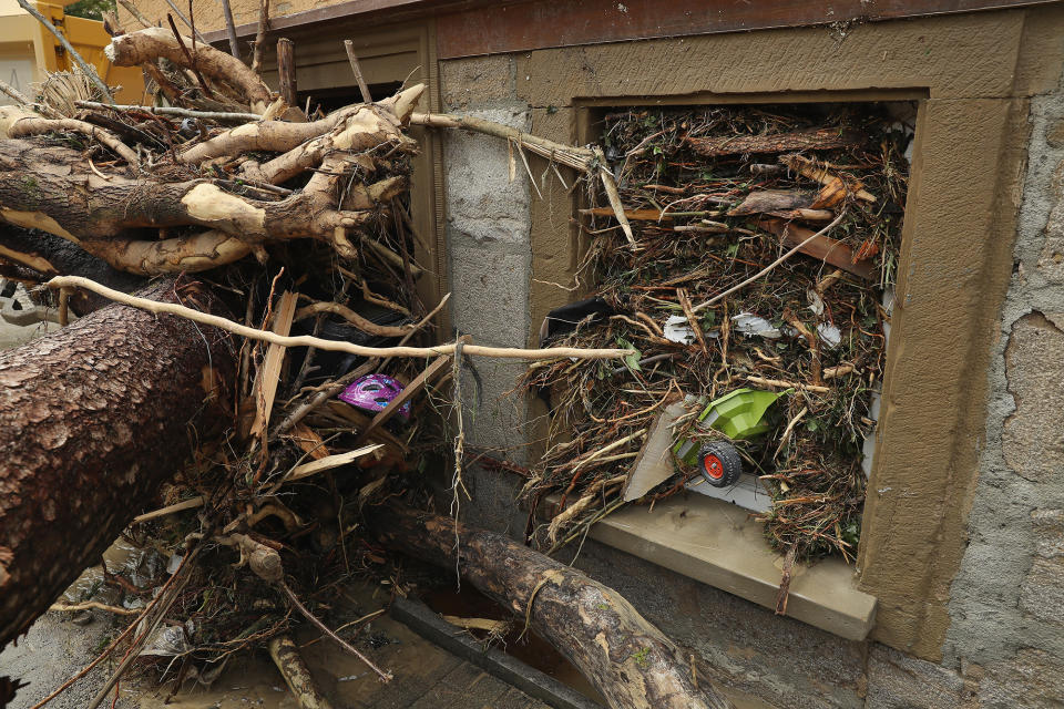 <p>A child’s toy and bits of smashed trees are wedged into a window in Braunsbach, Germany, on May 30, 2016, after a flash flood hit the town. (Sean Gallup/Getty Images) </p>