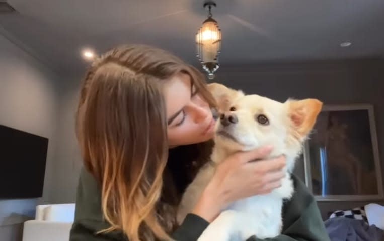 Kaia Gerber kissing her dog milo at home 