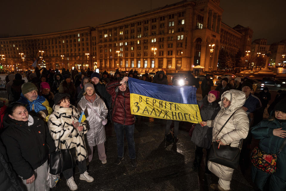 People hold a Ukrainian national flag during a protest a day after the resignation of General Valerii Zaluzhnyi at Independence Square in Kyiv, Ukraine, Friday, Feb. 9, 2024. (AP Photo/Evgeniy Maloletka)