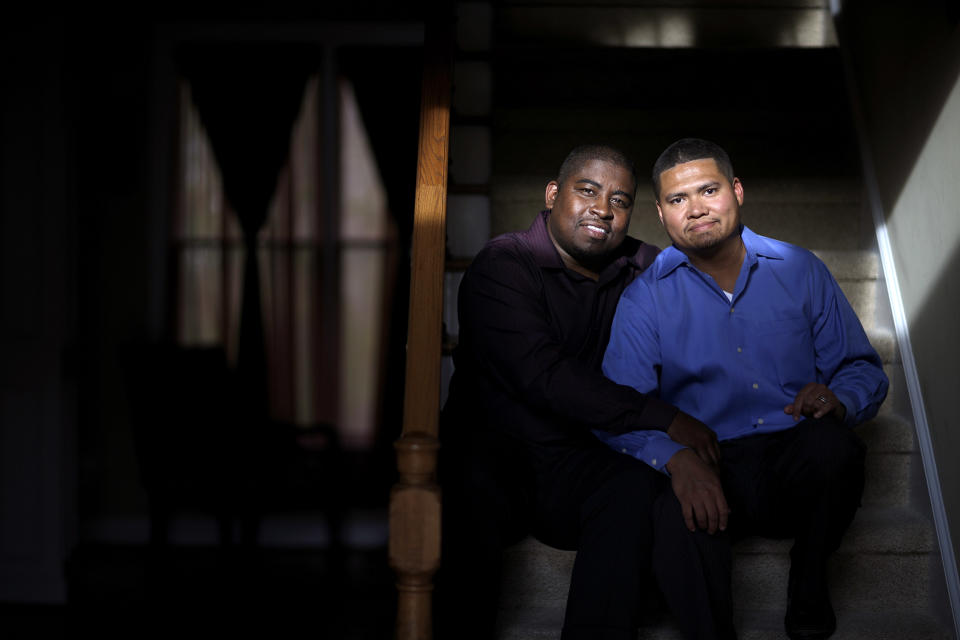 Shelton Stroman, left, sits with partner Christopher Inniss, in their home, Thursday, April 17, 2014, in Snellville, Ga. A gay rights group on Tuesday, April 22, 2014, filed a federal lawsuit in Atlanta challenging the state of Georgia’s constitutional ban on same-sex marriages. (AP Photo/David Goldman)