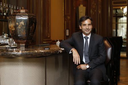 Nicolas Beliard, General Manager of the Peninsula Paris hotel, poses at the bar of the Peninsula Paris luxury hotel in Paris July 30, 2014. REUTERS/Benoit Tessier/Files