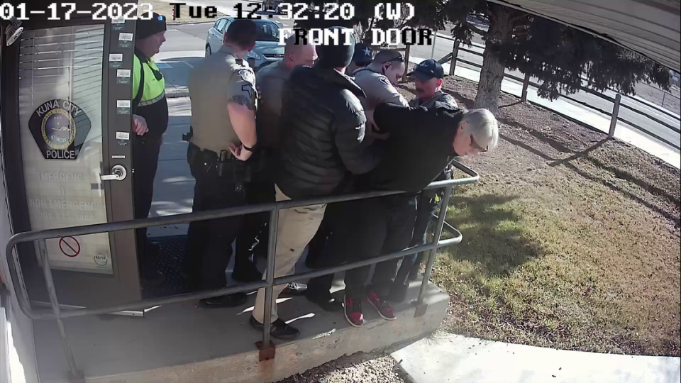 Police forced Mick Heikkola against the rail outside the Kuna Police Department station.
