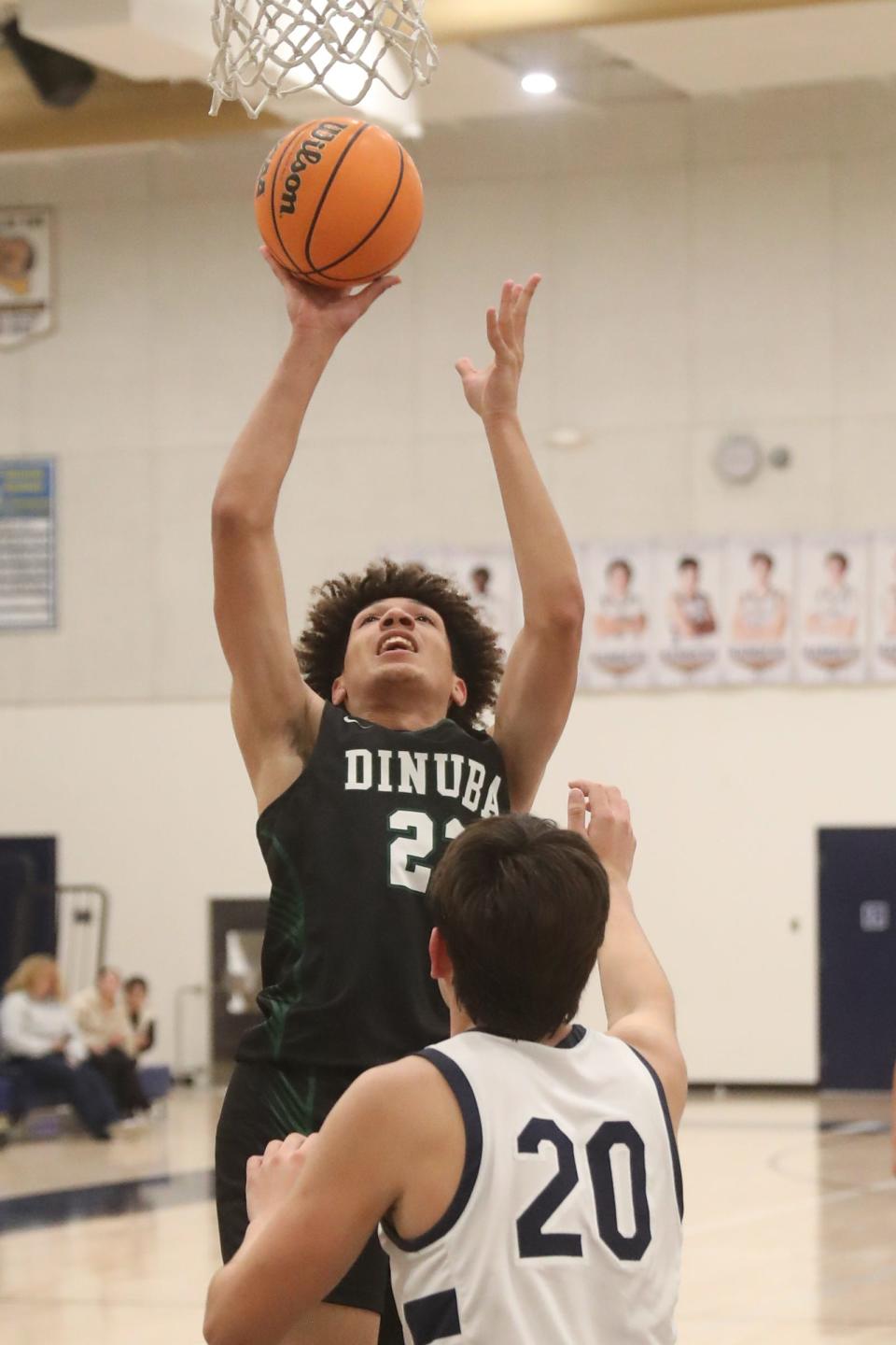 Dinuba's Brice Watley goes up for a shot against Redwood in a non-league high school boys basketball game on Tuesday, December 12, 2023.