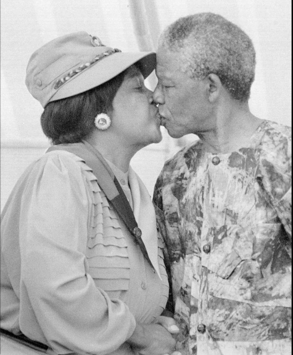 <p>President Nelson Mandela, right, kisses his wife, Winnie Mandela, at a rally in Cape Town in early 1993. Divorce proceedings between the couple began in Johannesburg’s Rand Supreme Court on March 18, 1996, with President Mandela accusing his wife of adultery. (Photo: Benny Gool/AP) </p>