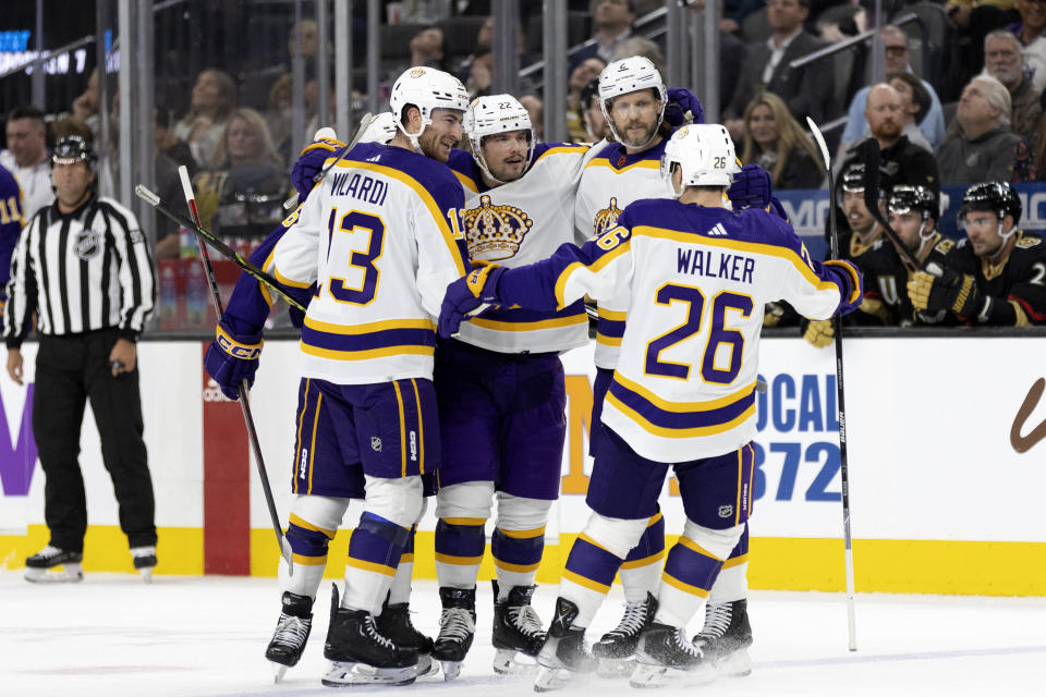 The Los Angeles Kings celebrate after left wing Kevin Fiala, center left, scored a goal against the Vegas Golden Knights during the first period of an NHL hockey game Saturday, Jan. 7, 2023, in Las Vegas. (AP Photo/Ellen Schmidt)