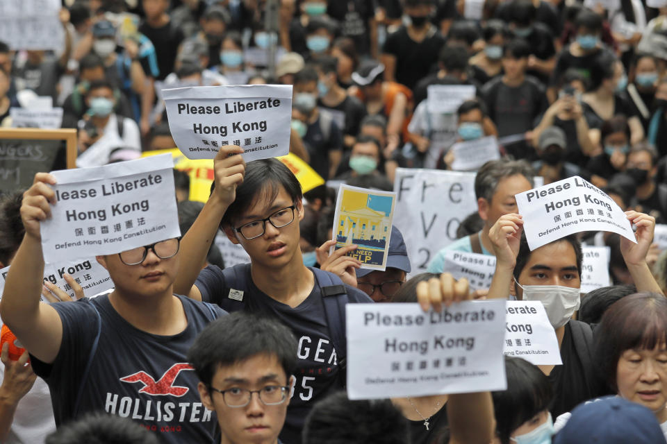 Protesters gather near the U.S. Consulate as they stage a protest in Hong Kong, Wednesday, June 26, 2019. Hong Kong activists opposed to contentious extradition legislation on Wednesday called on leaders of the U.S., the European Union and others to raise the issue with Chinese President Xi Jinping at this week's G-20 summit in Japan. (AP Photo/Kin Cheung)