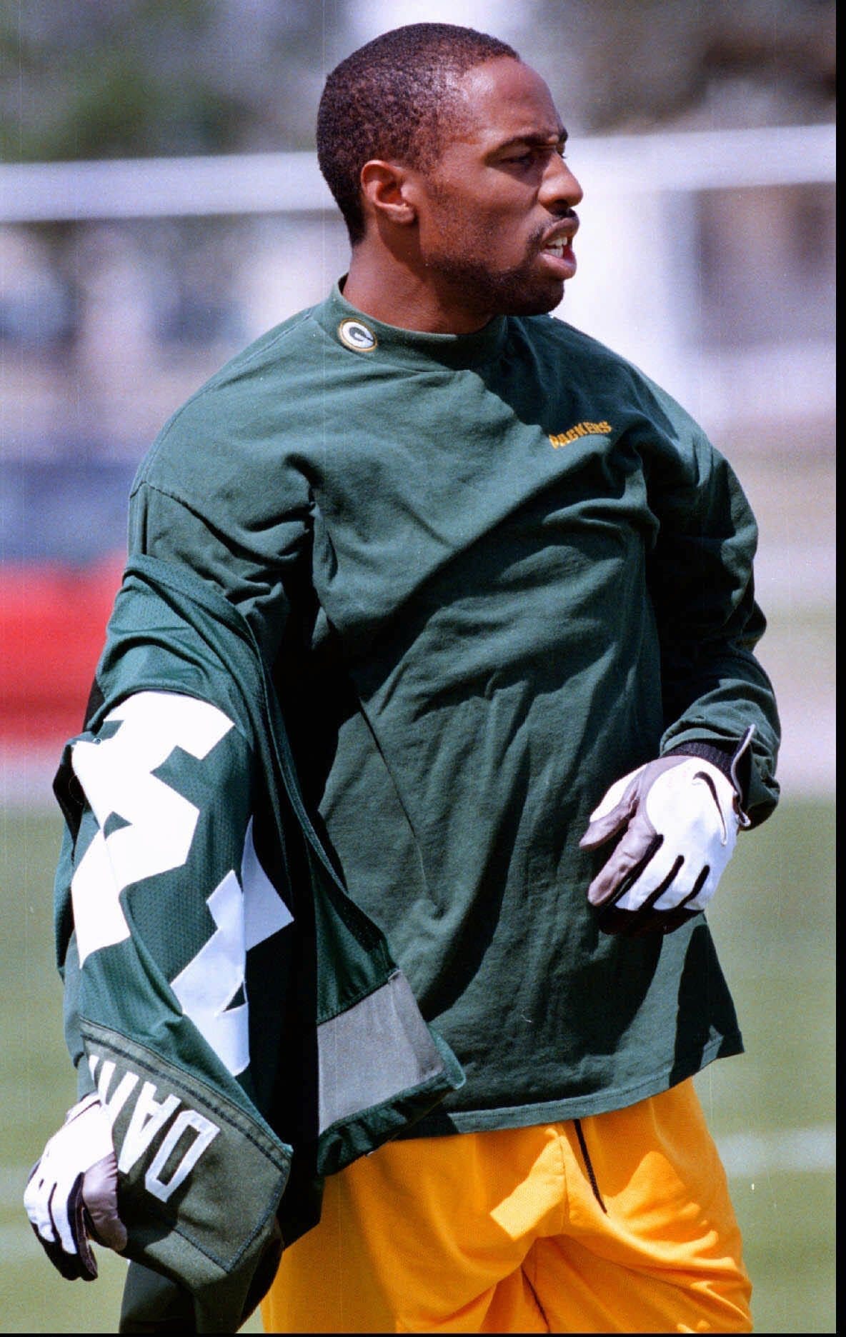 Green Bay Packers defensive back Chris Darkins takes off his jersey after minicamp practice.