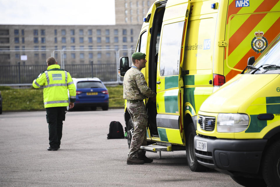 Military personnel and ambulance staff at the ExCel Center in London, Thursday, April 2, 2020, that is being turned into a 4000 bed temporary hospital know as NHS Nightingale to help deal with some of the coronavirus outbreak victims in London. The new coronavirus causes mild or moderate symptoms for most people, but for some, especially older adults and people with existing health problems, it can cause more severe illness or death. (AP Photo/Alberto Pezzali)