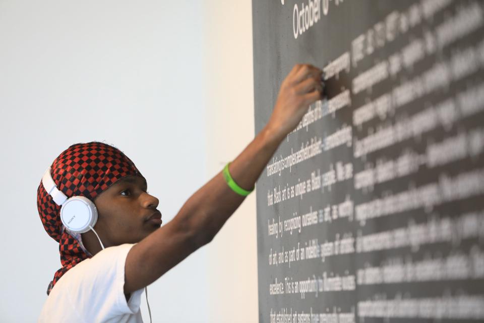 Jaydee Thomas, a student at the Art Effect helps take down an exhibit at the Trolley Barn in the City of Poughkeepsie on December 6, 2023.