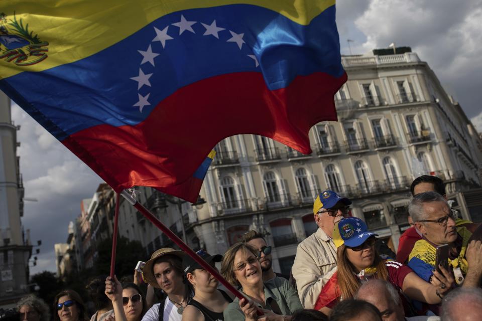 Supporters of Venezuelan opposition leader Juan Guaido gather in Madrid, Spain, Tuesday, April 30, 2019. Thousands of Venezuelans have migrated to Spain in recent years or are seeking asylum in the country, including prominent members of the opposition and former officials who worked closely with late Venezuelan President Hugo Chavez. More than 177,000 Spaniards live in Venezuela. (AP Photo/Bernat Armangue)