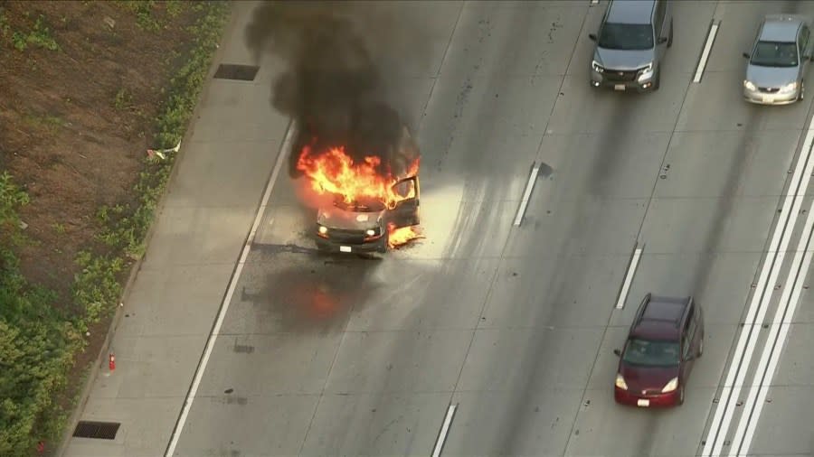 A burning van on the 105 Freeway in the City of Paramount caused delays for commuters early Monday morning. (Sky5)