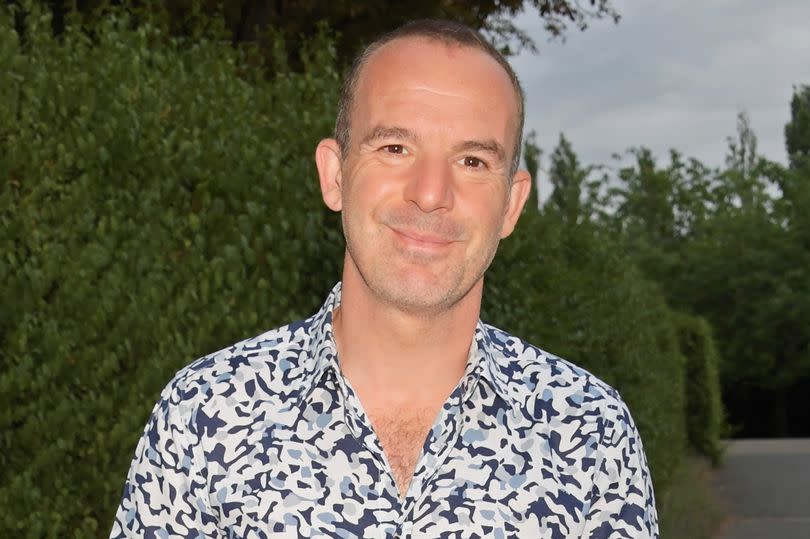 Martin Lewis attends the press night performance of new musical "101 Dalmatians" - he's wearing a bold black and white shirt, with blue jeans and black trainers
