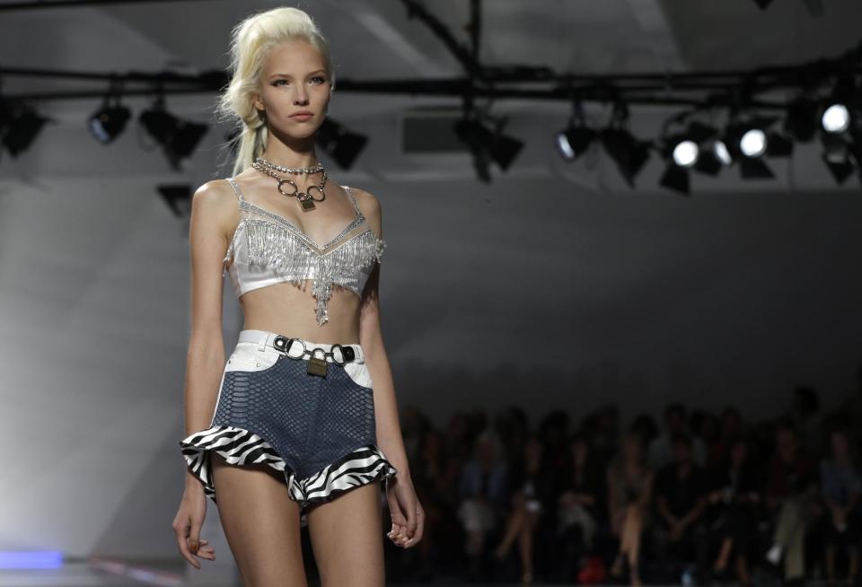 The Rodarte Spring 2014 collection is modeled during Fashion Week in New York, Tuesday, Sept. 10, 2013. (AP Photo/Seth Wenig)