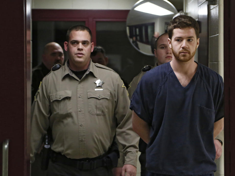 Cody Cousins, right, walks down the hall, Thursday, Jan. 23, 2014, inside the Tippecanoe County Jail in Lafayette, Ind., on the way to his initial hearing on charges of murder in Tuesday's shooting and stabbing death of engineering student Andrew Boldt on the campus of Purdue University. (AP Photo/Journal & Courier, John Terhune, Pool)