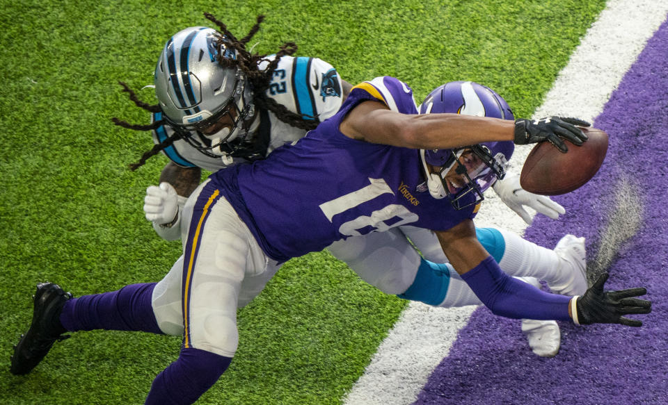 Minnesota Vikings wide receiver Justin Jefferson (18) dives past Carolina Panthers cornerback Stantley Thomas-Oliver (23) to score his second touchdown of the day in the fourth quarter of an NFL football game in Minneapolis, Sunday, Nov. 29, 2020. (Alex Kormann/Star Tribune via AP)