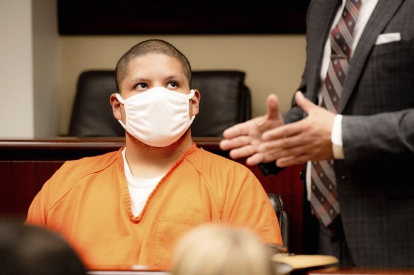 Joseph Jimenez, 20, left, looks at his attorney Charles Kenyon during his arraignment at the Riverside Hall of Justice in Riverside, Calif., on Thursday, Aug. 5, 2021. Jimenez is accused of fatally shooting Rylee Goodrich, 18, and Anthony Barajas, 19, in a Corona movie theater on July 26. (Watchara Phomicinda/The Orange County Register via AP)