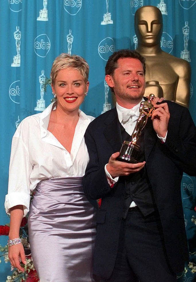 Sharon Stone, left, and director Mike van Diem as they pose for photographers backstage after he won an Oscar for Best Foreign-Language film at the 70th Academy Awards in Los Angeles on March 23, 1998. - Credit: AP