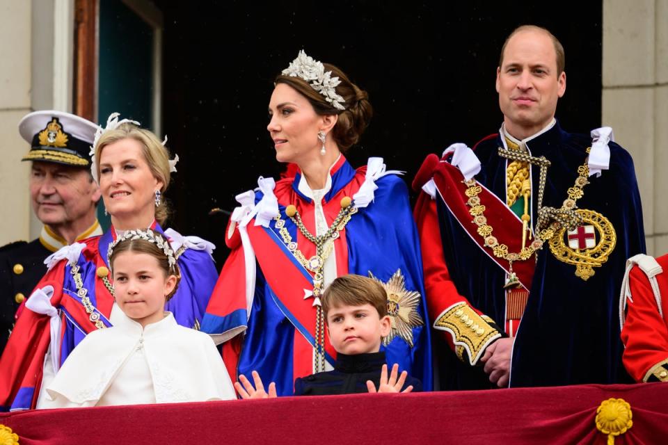 Prince Louis, five, gives an adorable two-handed wave to the crowds lining the Mall (PA)