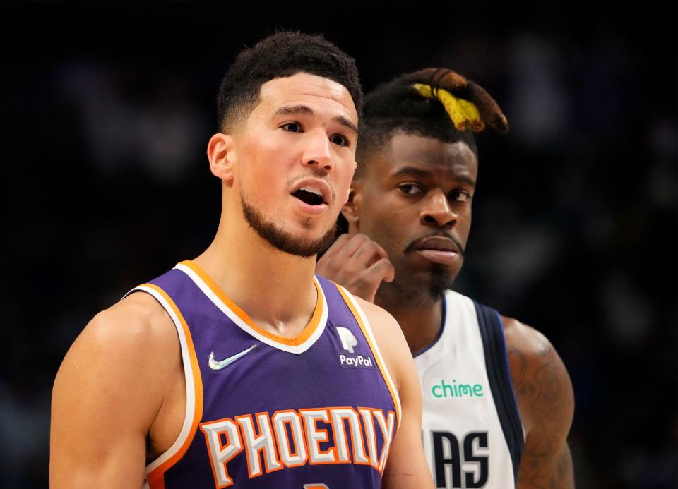 May 6, 2022; Dallas, Texas, USA; Phoenix Suns guard Devin Booker (1) reacts as Dallas Mavericks forward Reggie Bullock (25) watches during game three of the second round for the 2022 NBA playoffs at American Airlines Center.
