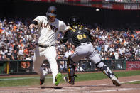 San Francisco Giants' Joc Pederson, left, scores on Wilmer Flores' RBI double past Pittsburgh Pirates catcher Jason Delay during the fourth inning of a baseball game in San Francisco, Sunday, Aug. 14, 2022. (AP Photo/Jeff Chiu)