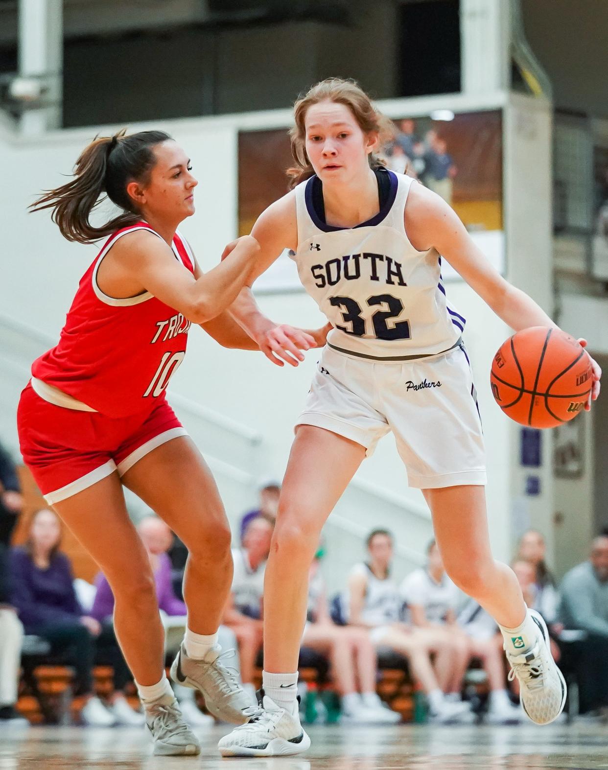 Bloomington South’s Julia Lashley (32) dribbles against Center Grove’s Hannah Gin (10) during their girls’ basketball game at South on Thursday, Dec. 7, 2023.