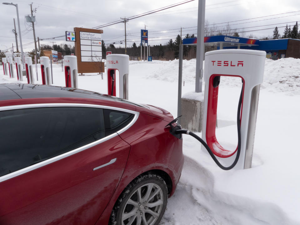 A red electric vehicle sits at a charging station in Montréal, Canada. (Photo by François LOCHON/Gamma-Rapho via Getty Images)