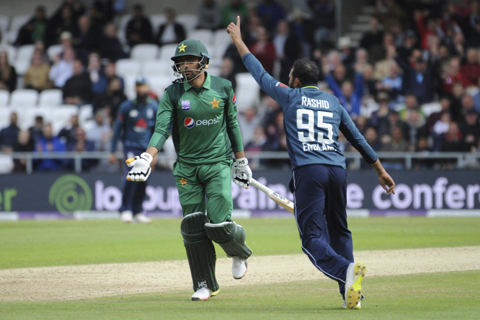 Pakistan's Babar Azam, left, is run out by England's Adil Rashid, left, during the Fifth One Day International cricket match between England and Pakistan at Emerald Headingley in Leeds, England, Sunday, May 19, 2019. (AP Photo/Rui Vieira)