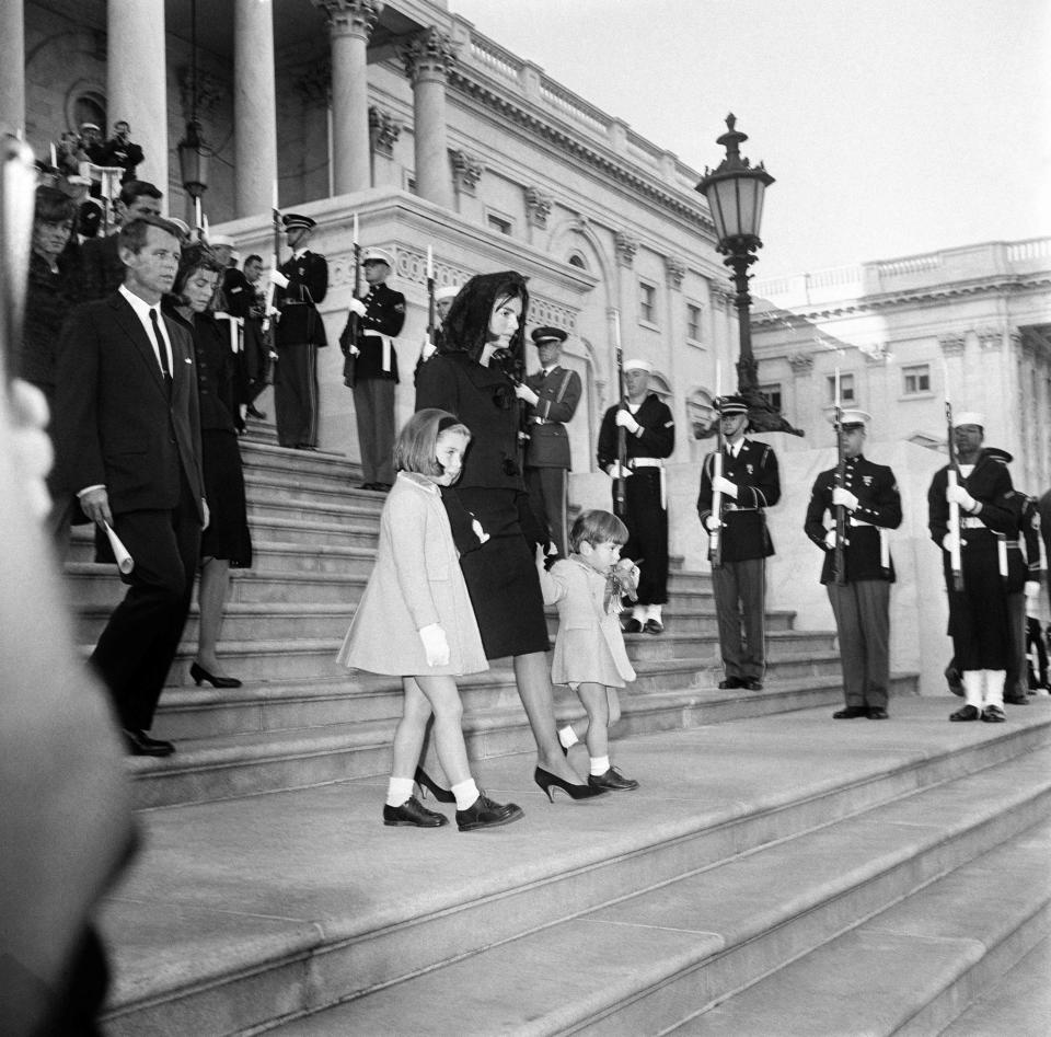 US First Lady Jacqueline Kennedy (C) and her children, Caroline Kennedy and John F. Kennedy, Jr. (R), exit the US Capitol Building where US slain President John Fitzgerald Kennedy lies in state on November 24, 1963 in Washington DC, accompanied by Kennedy family members Robert Kennedy (2nd L), Patricia Kennedy Lawford (L) and Jean Kennedy Smith (3rd L).