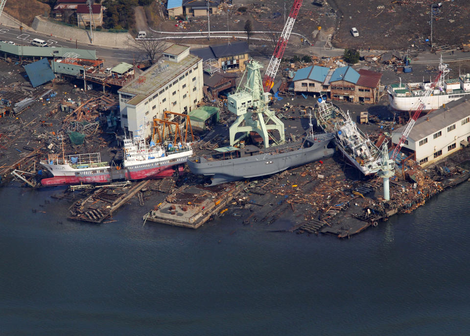 FILE - Ships washed away by tsunami sit on the land near a port in Kesennuma, Miyagi Prefecture, Japan, on March 13, 2011, after Japan's biggest recorded earthquake hit its eastern coast on March 11. The 2011 quake, tsunami and nuclear meltdown in northern Japan provides a glimpse of what Turkey and Syria could face in the years ahead. No two events are alike, but the recent disaster resembles Japan's in the sheer enormity of the psychological trauma, of the loss of life and of the material destruction. (AP Photo/Itsuo Inouye, File)