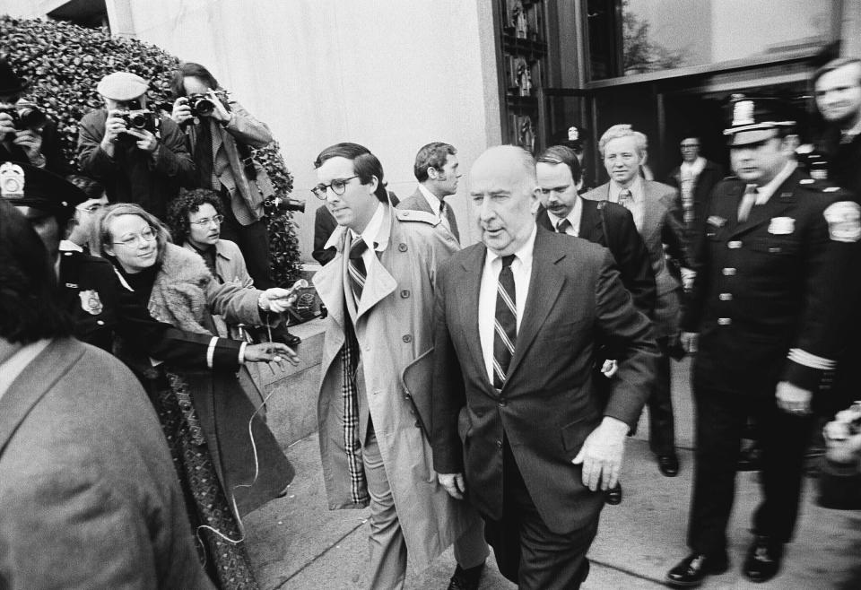 FILE - John N. Mitchell, one of six persons charged in the Watergate scandal, walks outside U.S. District Court in Washington, March 9, 1974, where he faced arraignment. Mitchell was eventually convicted of conspiracy, perjury and obstruction of justice related to the Watergate scandal that brought down President Richard Nixon. Once the nation's top law enforcement officer, Mitchell ultimately served 19 months in prison. (AP Photo, File)