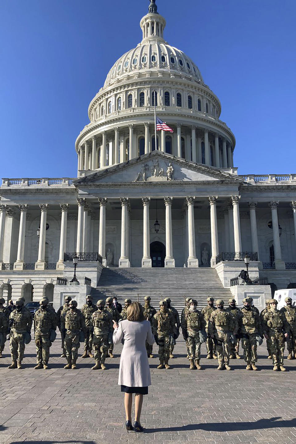 This image released by the Speaker of the House Nancy Pelosi's Office, Pelosi speaks to National Guard troops outside the U.S. Capitol on Wednesday, Jan. 13, 2021, in Washington. (Drew Hammill/Speaker of the House Nancy Pelosi's Office via AP)