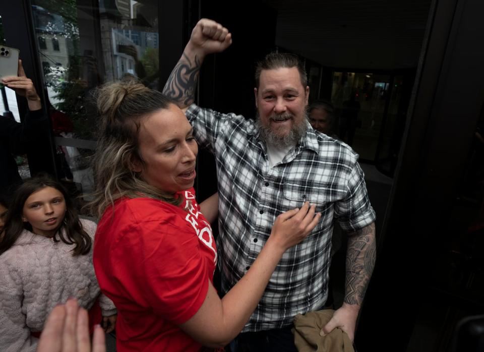 Pat King pumps his fist in the air as he emerges from the courthouse after receiving bail, Monday, July 18, 2022 in Ottawa.