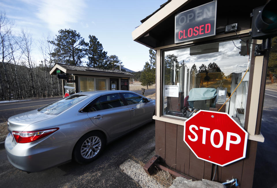 <p>A vehicle passes freely into Rocky Mountain National Park past the unmanned collection booths as national parks remain as “accessible as possible” during a government shutdown Saturday, Jan. 20, 2018, in Estes Park, Colo. (Photo: David Zalubowski/AP) </p>