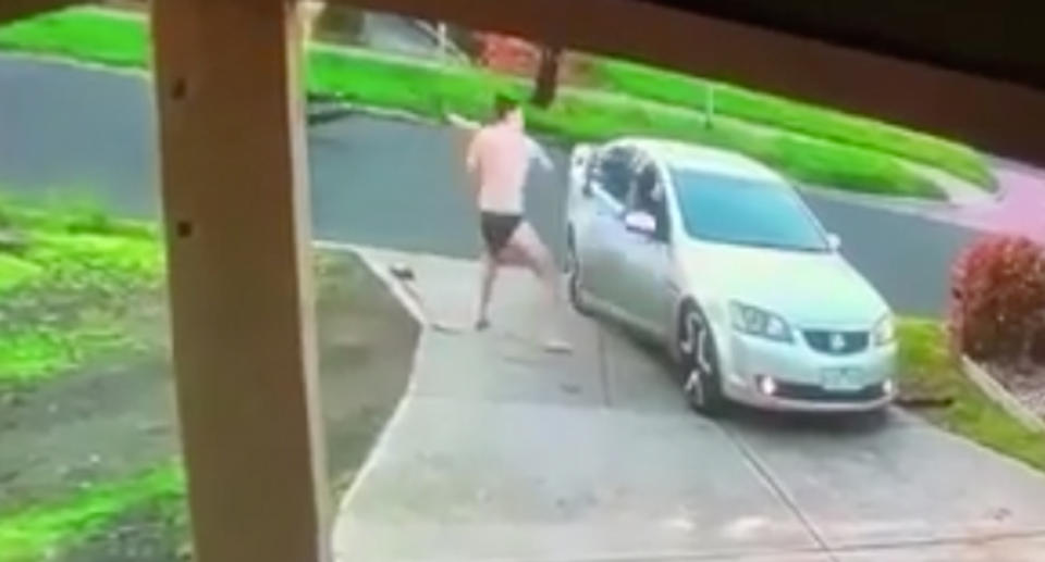 A man in his undies is pictured hitting a car with a baseball bat. 