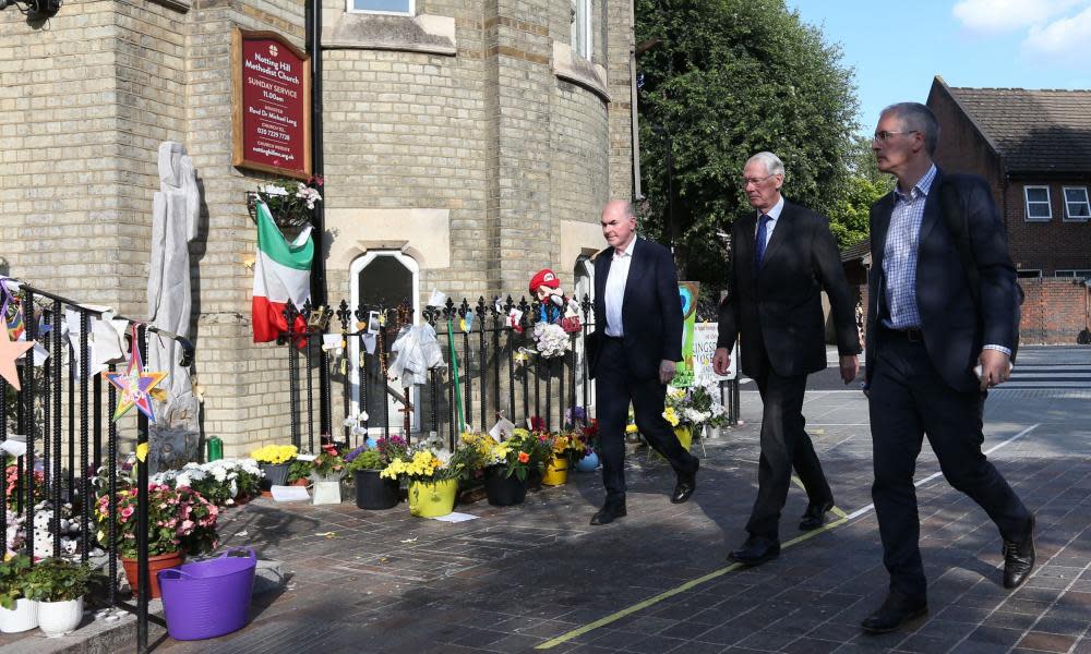 Sir Martin Moore-Bick, centre, arrives to speak at the meeting about the Grenfell Tower fire at Notting Hill Methodist church.