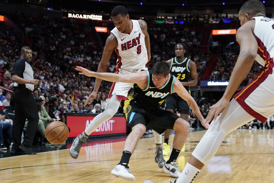 Indiana Pacers guard T.J. McConnell (9) loses control of the ball as Miami Heat forward Jamal Cain (8) defends during the first half of an NBA basketball game Saturday, Dec. 2, 2023, in Miami. (AP Photo/Lynne Sladky)