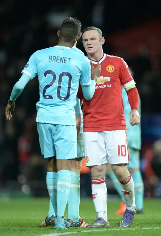 Manchester United's striker Wayne Rooney (R) speaks with PSV Eindhoven's defender Joshua Brenet after a 0-0 draw in a UEFA Champions League Group match at Old Trafford Stadium on November 25, 2015