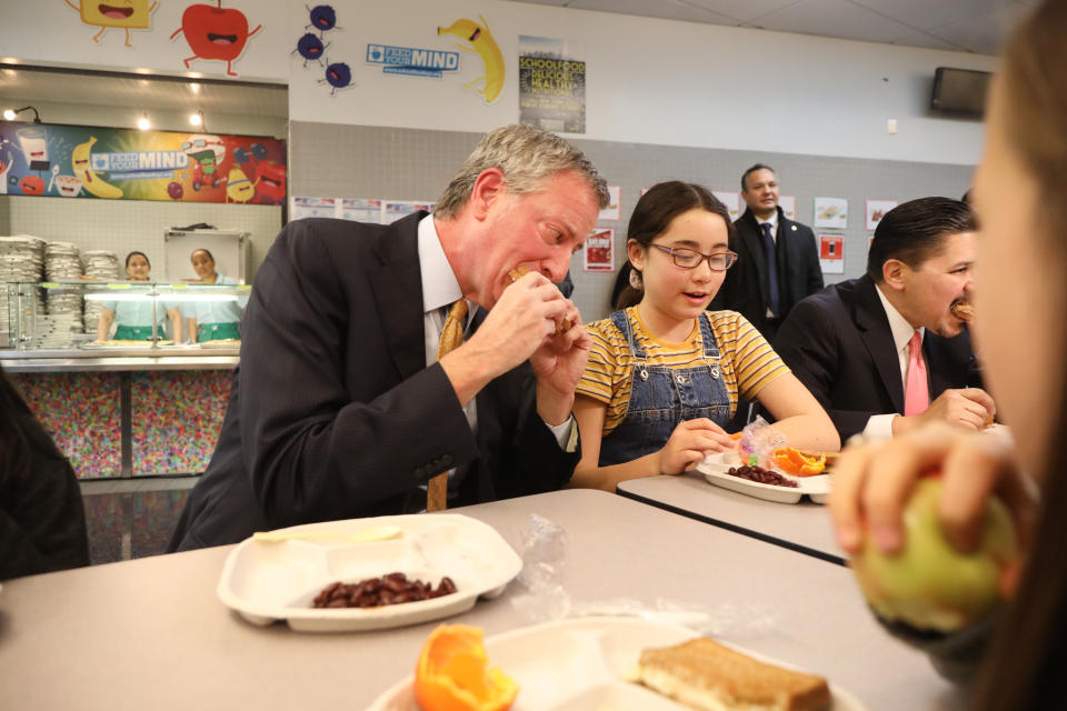 New York Mayor Bill de Blasio takes a bite during Meatless Monday, a vegetarian lunch initiative for the city's public schools on March 11.